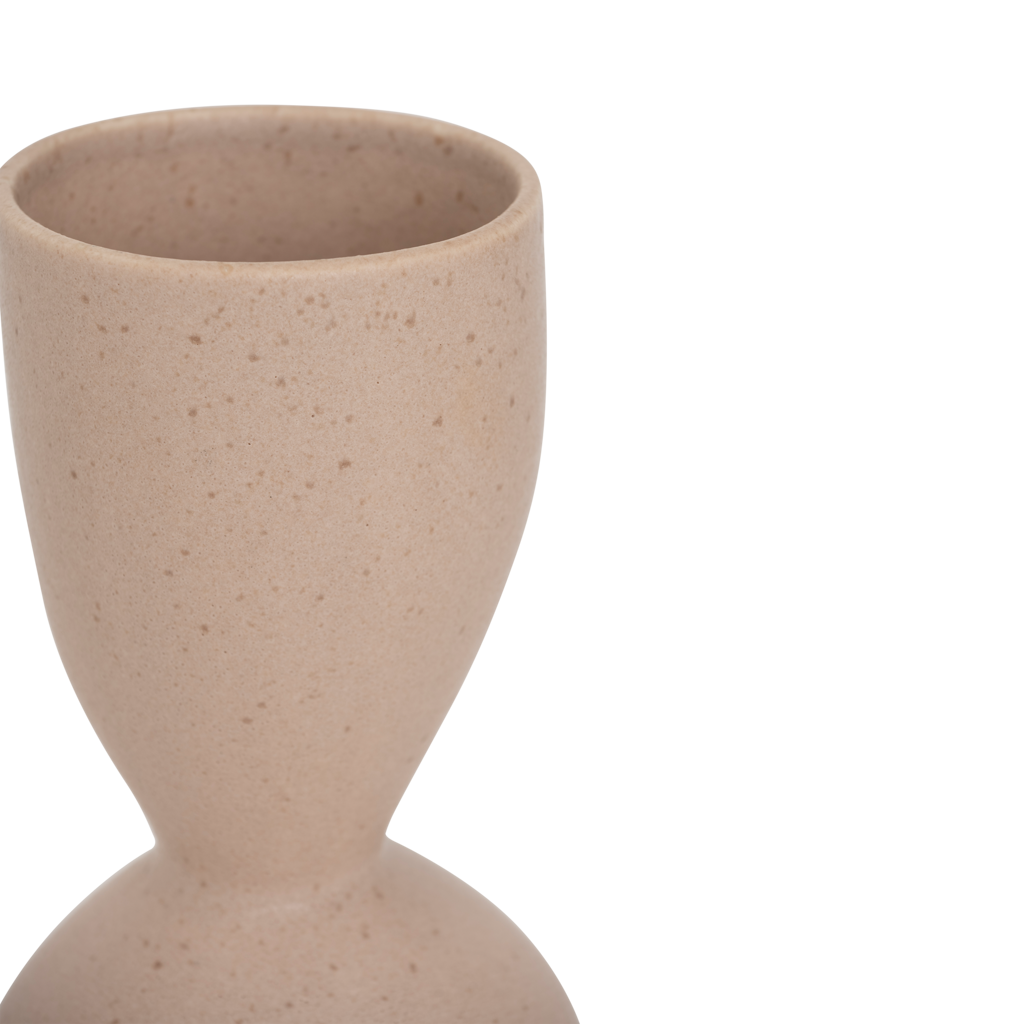 A ceramic vase with a graceful, feminine silhouette and a subtle indentation, finished in the soft natural colour rose smoke. Refined matt reactive glaze.