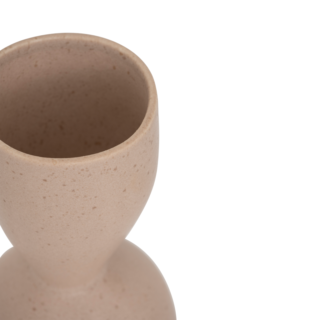 A ceramic vase with a graceful, feminine silhouette and a subtle indentation, finished in the soft natural colour rose smoke. Refined matt reactive glaze.