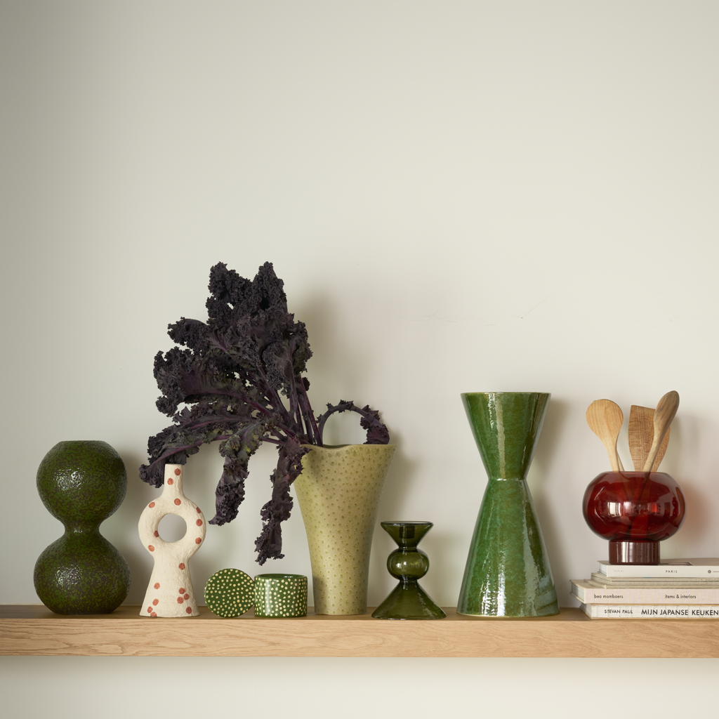 A vase composed of two smoothly stacked, flowing spheres, finished in the rich colour banana palm on a darkbrown base, in a reactive glaze. Crafted from a balanced mix of recycled and virgin ceramics.