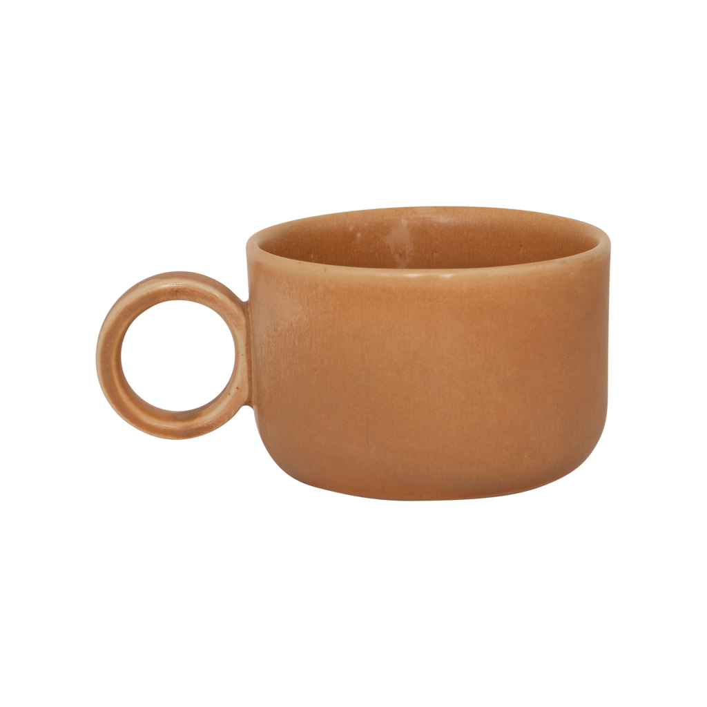A ceramic mug in mid-brown in a reactive glaze with a large rounded handle, giving it a sculptural, contemporary look. Made from a balanced mix of recycled and virgin ceramics.