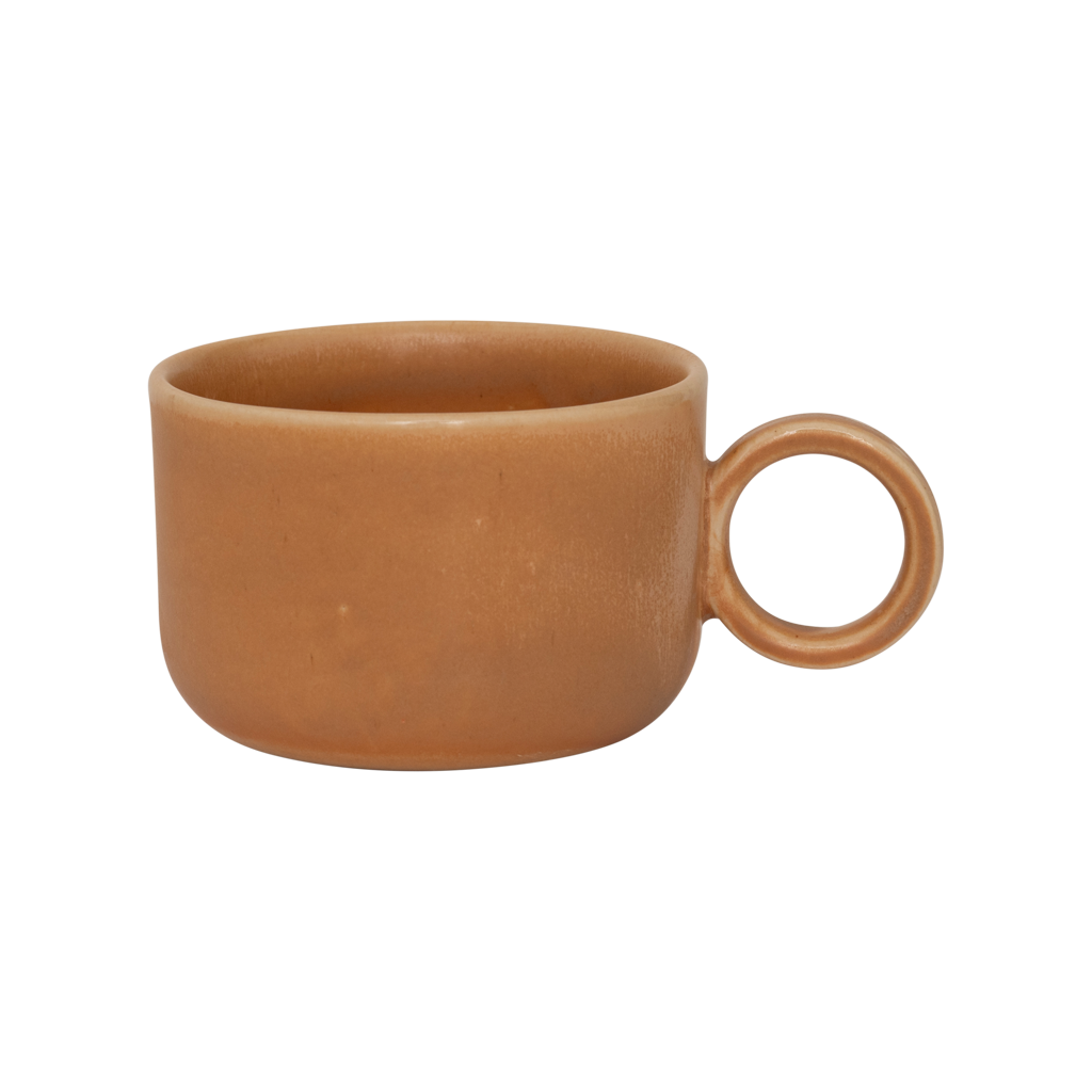 A ceramic mug in mid-brown in a reactive glaze with a large rounded handle, giving it a sculptural, contemporary look. Made from a balanced mix of recycled and virgin ceramics.