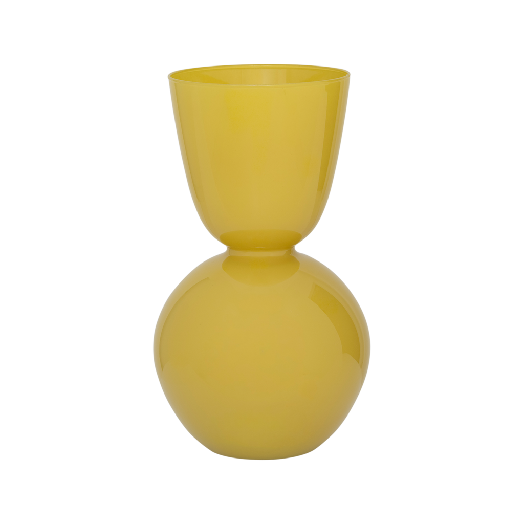 A recycled glass vase with a rounded form and a subtly flared opening, its silhouette flowing inward at the centre to create a balanced, feminine shape. In the vibrant opaque coloured yellow yasmine.