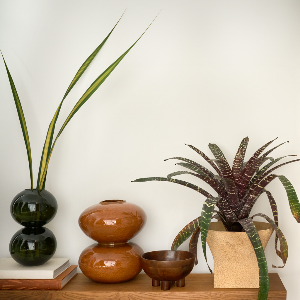 A large recycled glass vase with two layered spherical forms, balanced in the vivid and deep banana palm colour. Transparant coloured.