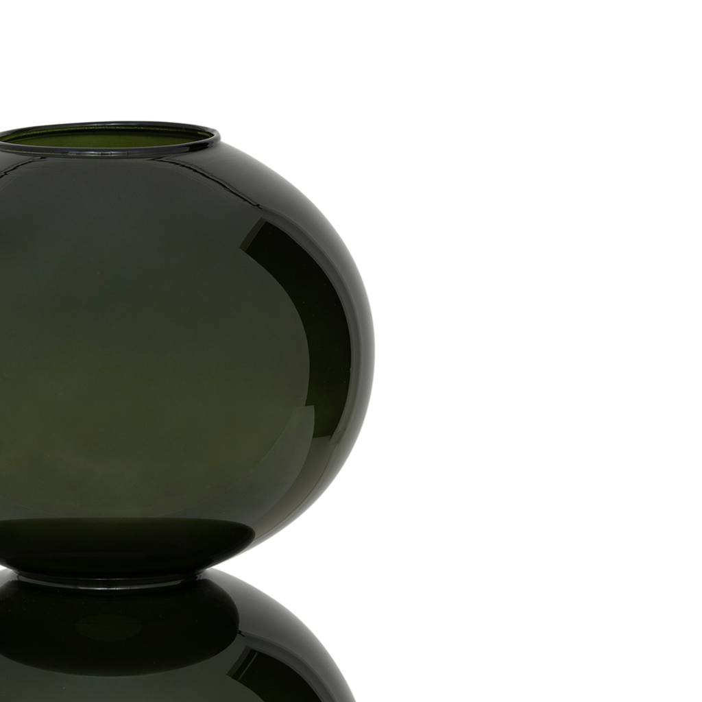 A large recycled glass vase with two layered spherical forms, balanced in the vivid and deep banana palm colour. Transparant coloured.