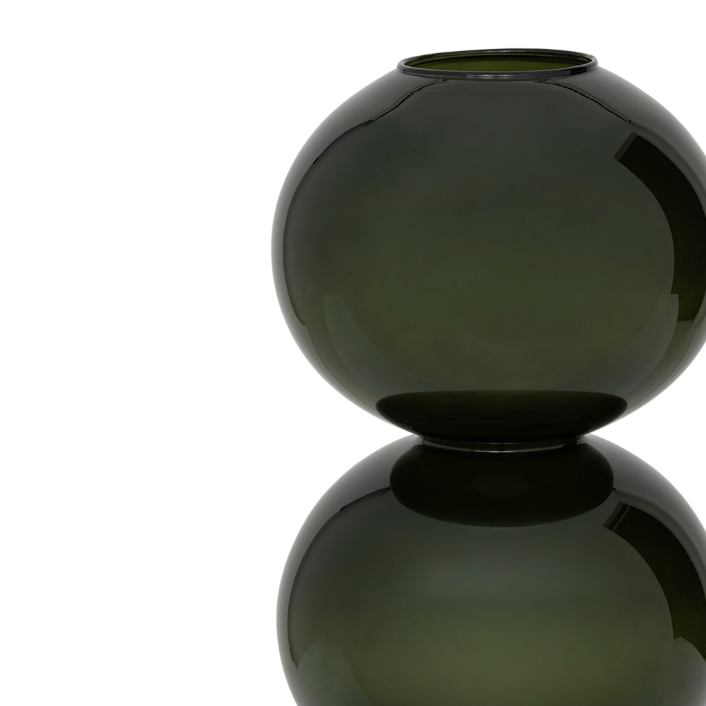 A large recycled glass vase with two layered spherical forms, balanced in the vivid and deep banana palm colour. Transparant coloured.