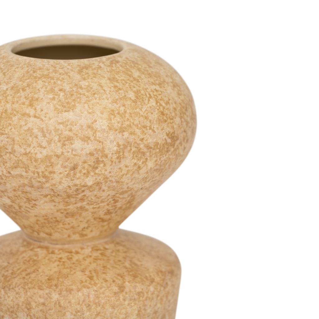 A ceramic vase with a modern shape where soft curves meet clean, straight lines, in the colour pale khaki with a matt sponged finish