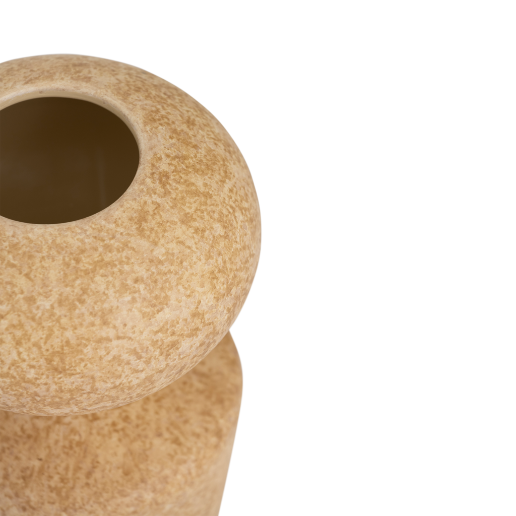 A ceramic vase with a modern shape where soft curves meet clean, straight lines, in the colour pale khaki with a matt sponged finish