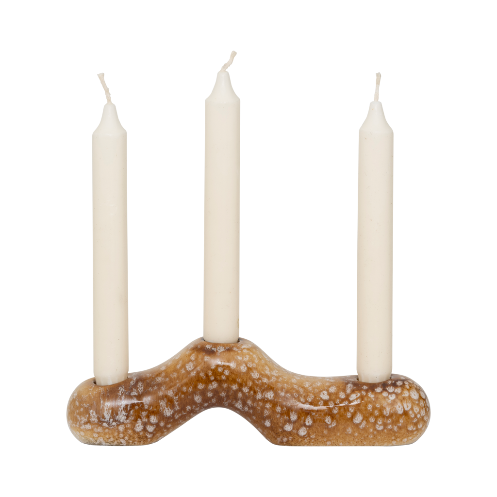 A horizontal candleholder for three candles - organic design. Made from a balanced mix of recycled and virgin ceramics. Finished in a lively brown shiny reactive glaze with outspoken tonal variation.