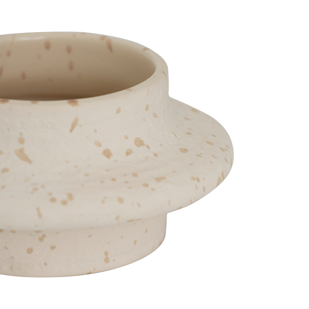 An XL tealight holder crafted from a mix of recycled and virgin ceramics, featuring a flowing form that feels playful yet calm. The off-white colour with speckles has a matt exterior and a shiny interior for subtle contrast.