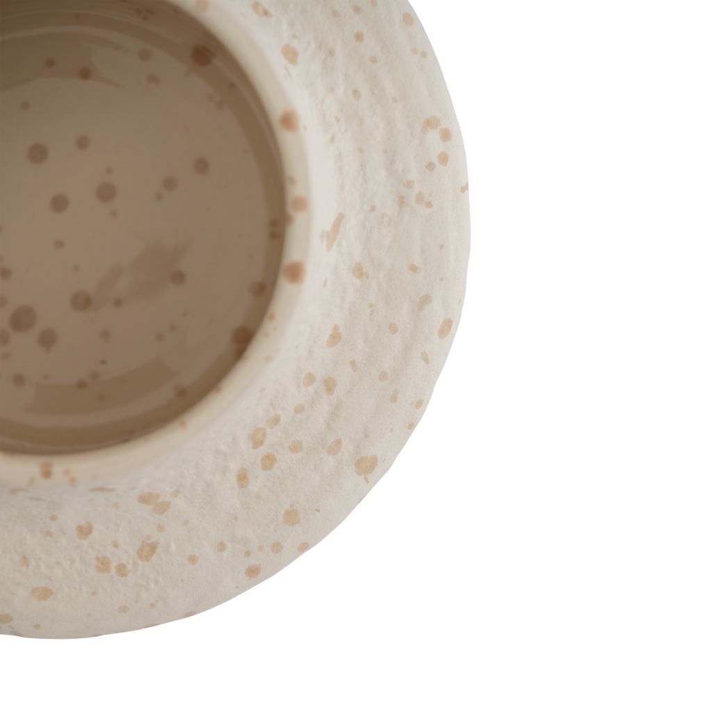 An XL tealight holder crafted from a mix of recycled and virgin ceramics, featuring a flowing form that feels playful yet calm. The off-white colour with speckles has a matt exterior and a shiny interior for subtle contrast.