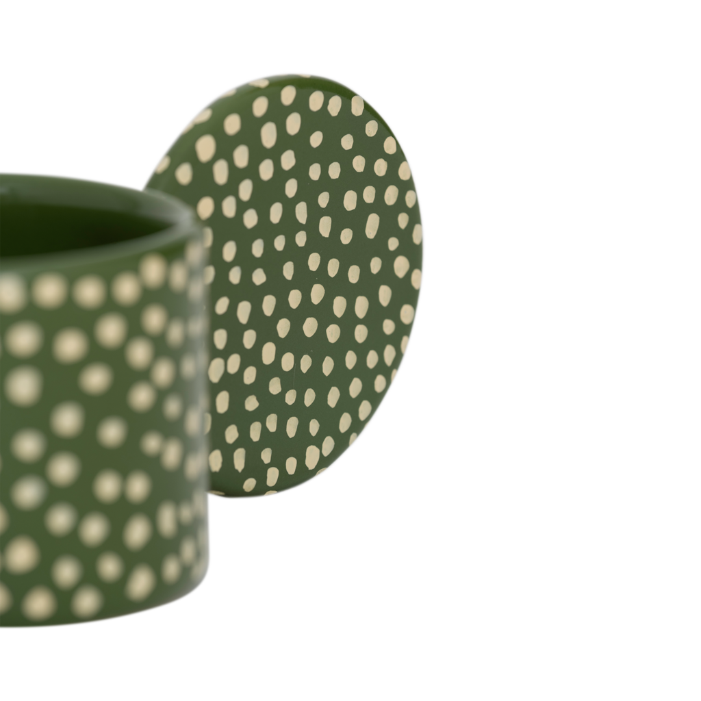 An XL tealight holder crafted from a mix of recycled and virgin ceramics. In a playful design with big ear and in a finish of handmade organic dots. In a vibrant banana palm base colour with vanilla coloured dots.