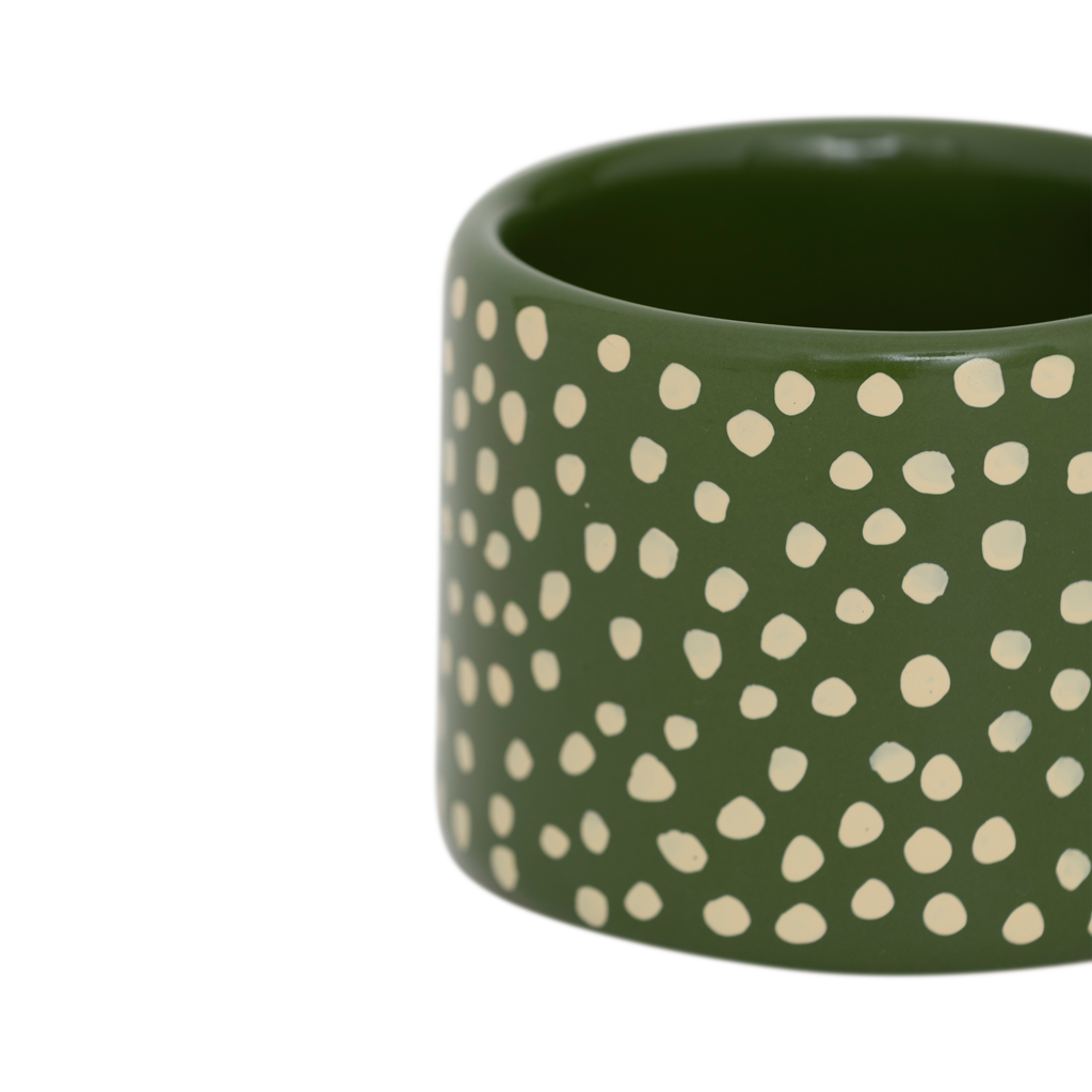 An XL tealight holder crafted from a mix of recycled and virgin ceramics. In a playful design with big ear and in a finish of handmade organic dots. In a vibrant banana palm base colour with vanilla coloured dots.