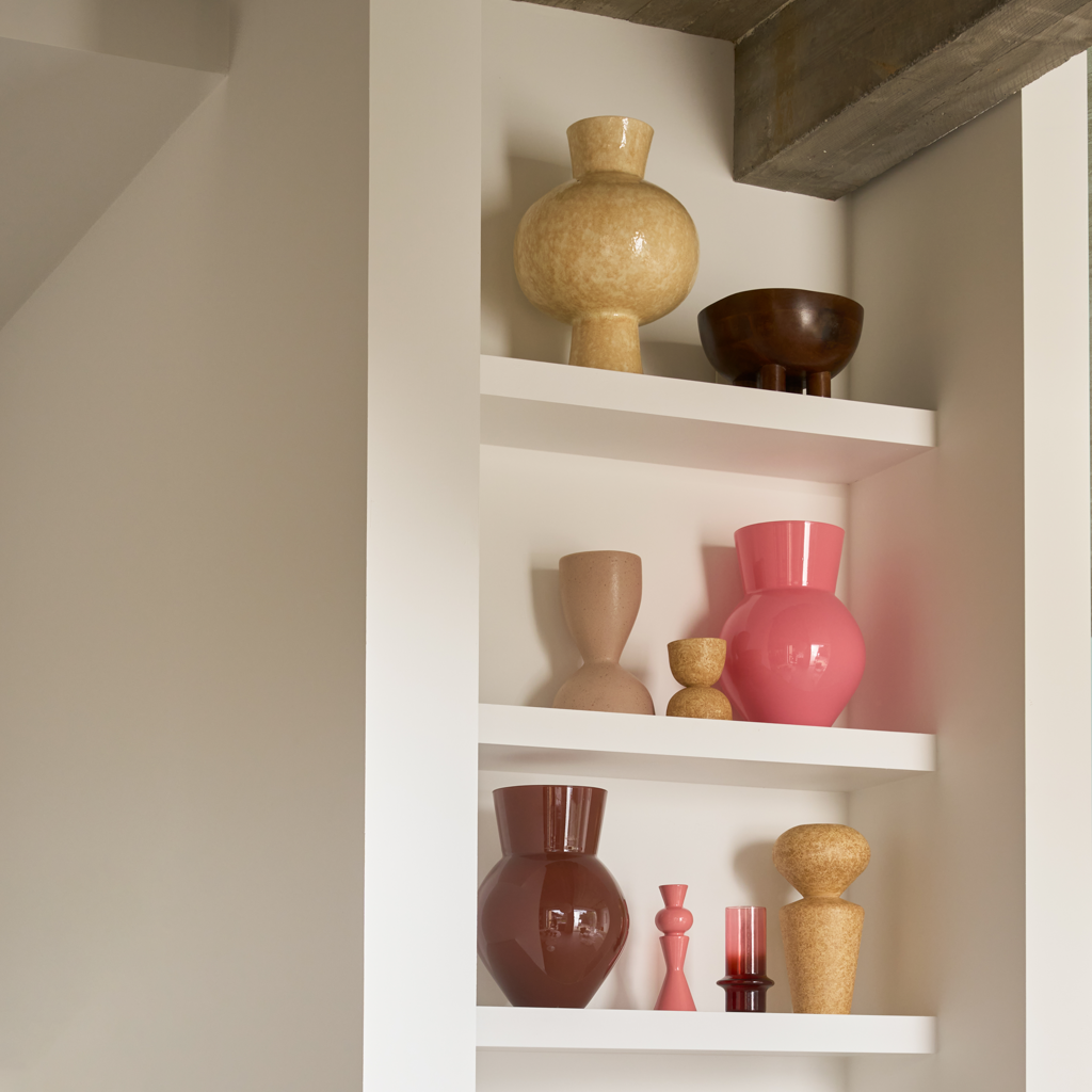A candleholder composed of a mix of geometric shapes that come together in an engaging design, crafted from a balanced mix of recycled and virgin ceramics. In blush, an romantic and bright colour.