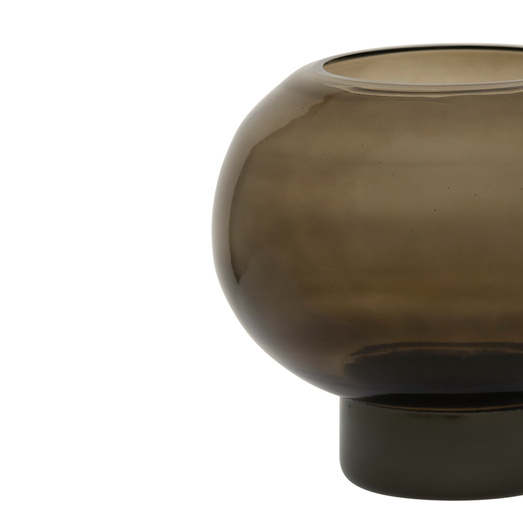 A recycled glass candleholder in deep, earthy kalamata, with a sculptural, graphic shape.