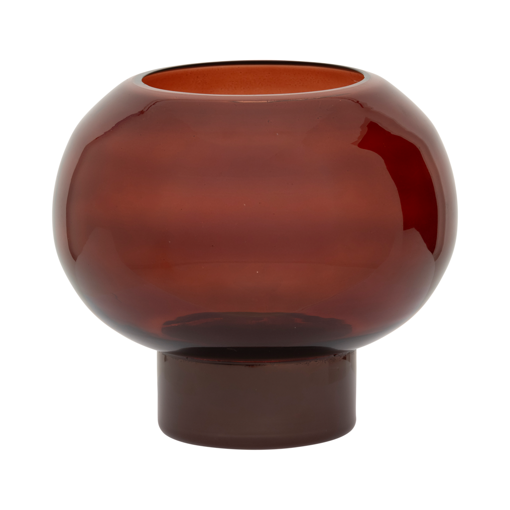 A recycled glass candleholder in deep, rich brandy, with a sculptural, graphic shape.