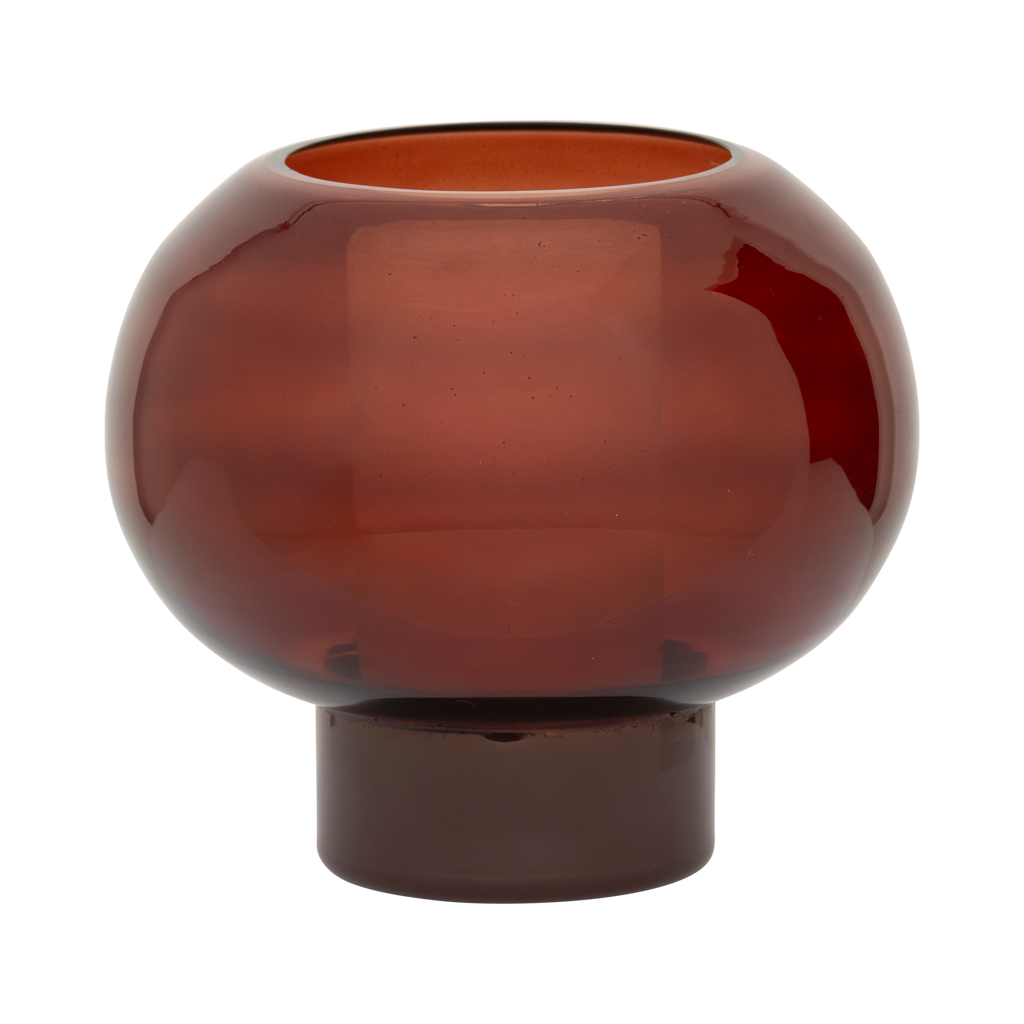 A recycled glass candleholder in deep, rich brandy, with a sculptural, graphic shape.