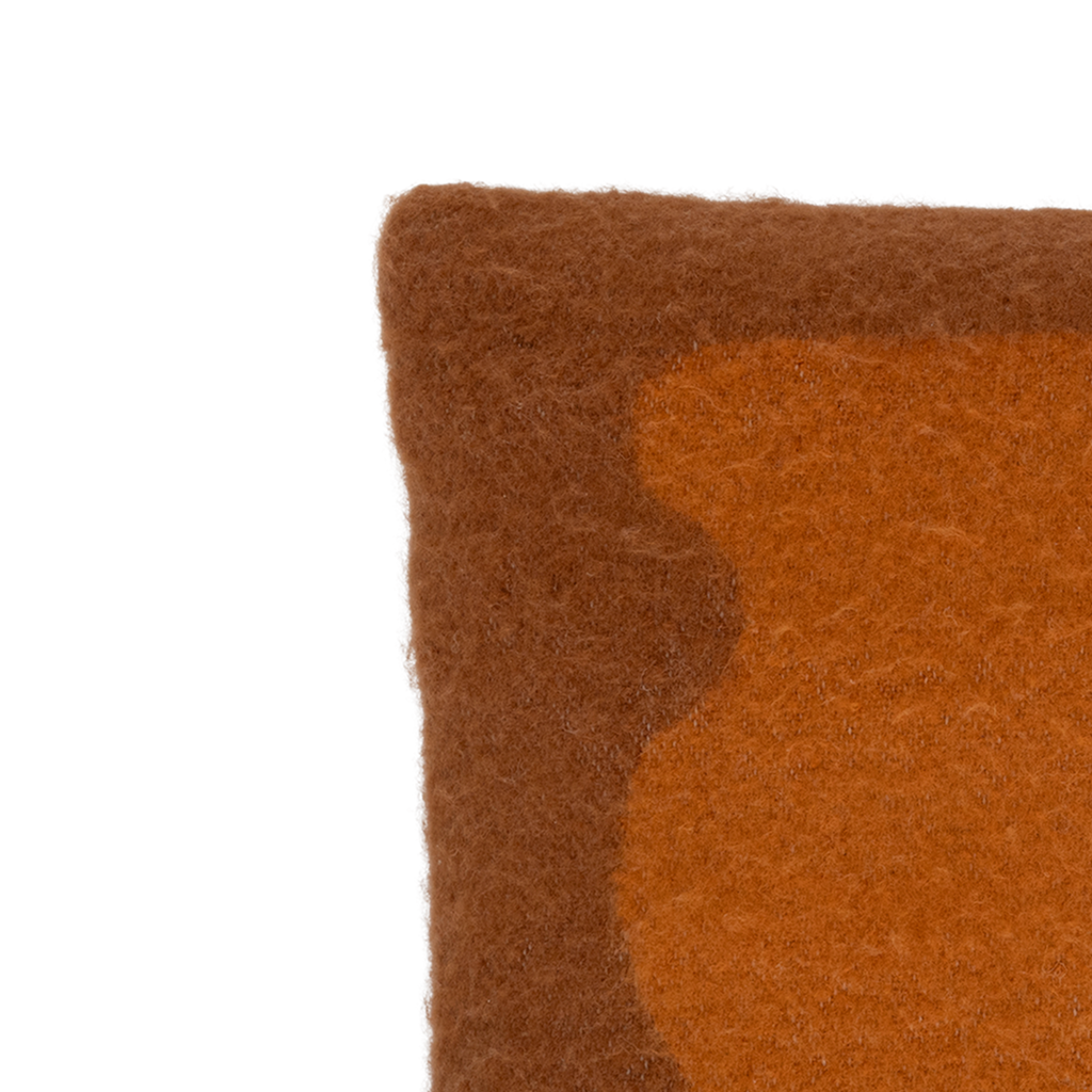A brushed wool blend cushion in the warm and inviting colour sugar almond with an deep orange a-symmetric organic artwork. Finished by an organic cotton line embroidery in off-white.