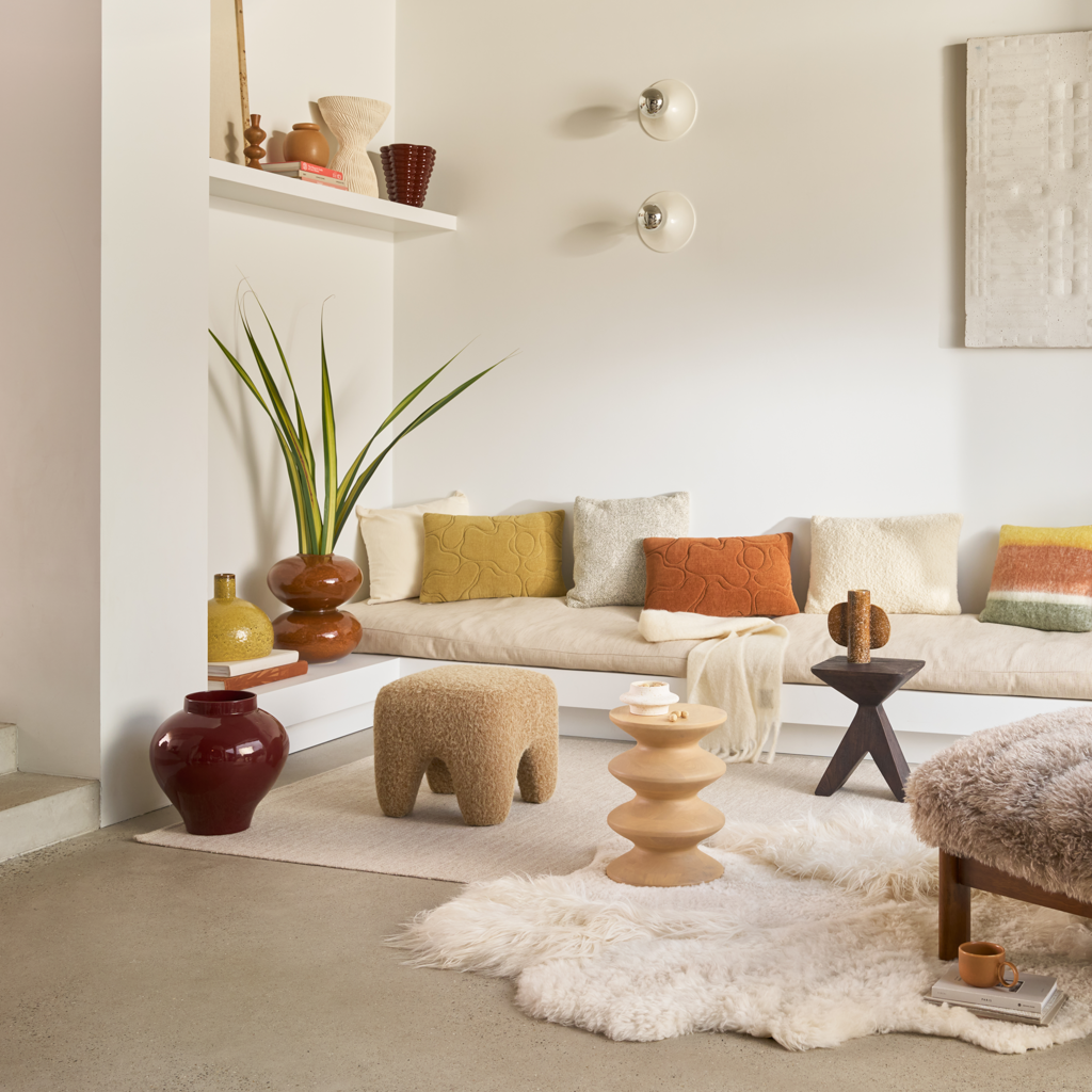 A cotton chenille decorative cushion in the warm, inviting colour sugar almond with a padded and quilted organic pattern.