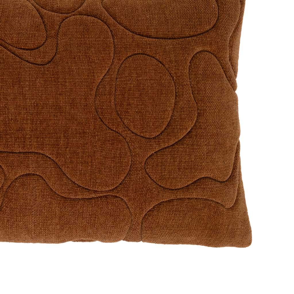 A cotton chenille decorative cushion in the warm, inviting colour sugar almond with a padded and quilted organic pattern.