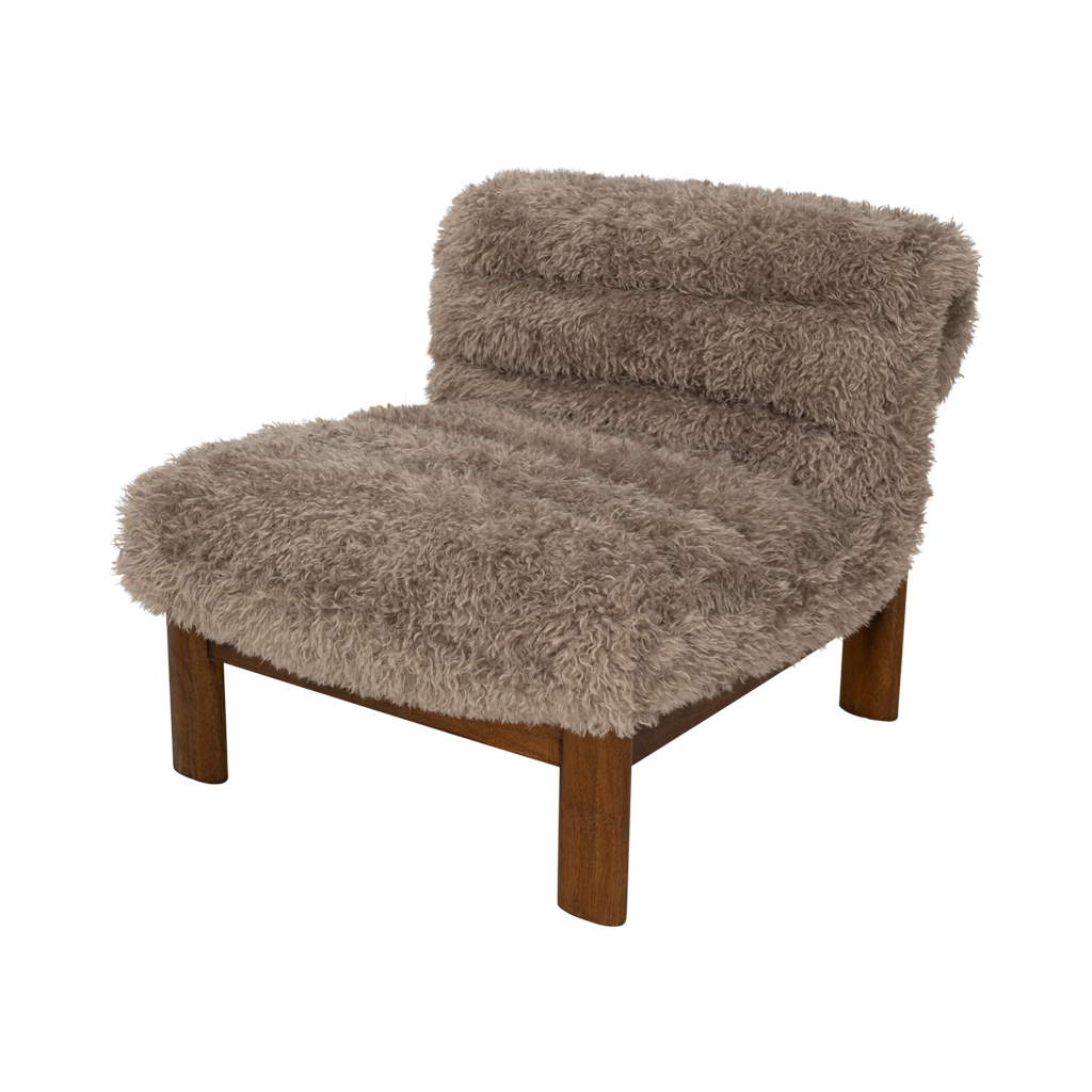A lounge chair with visible rubber wood legs and a quilted and padded cushioned seat in a draped design. Made from a fluffy poodle fabric in the versatile colour taupe.