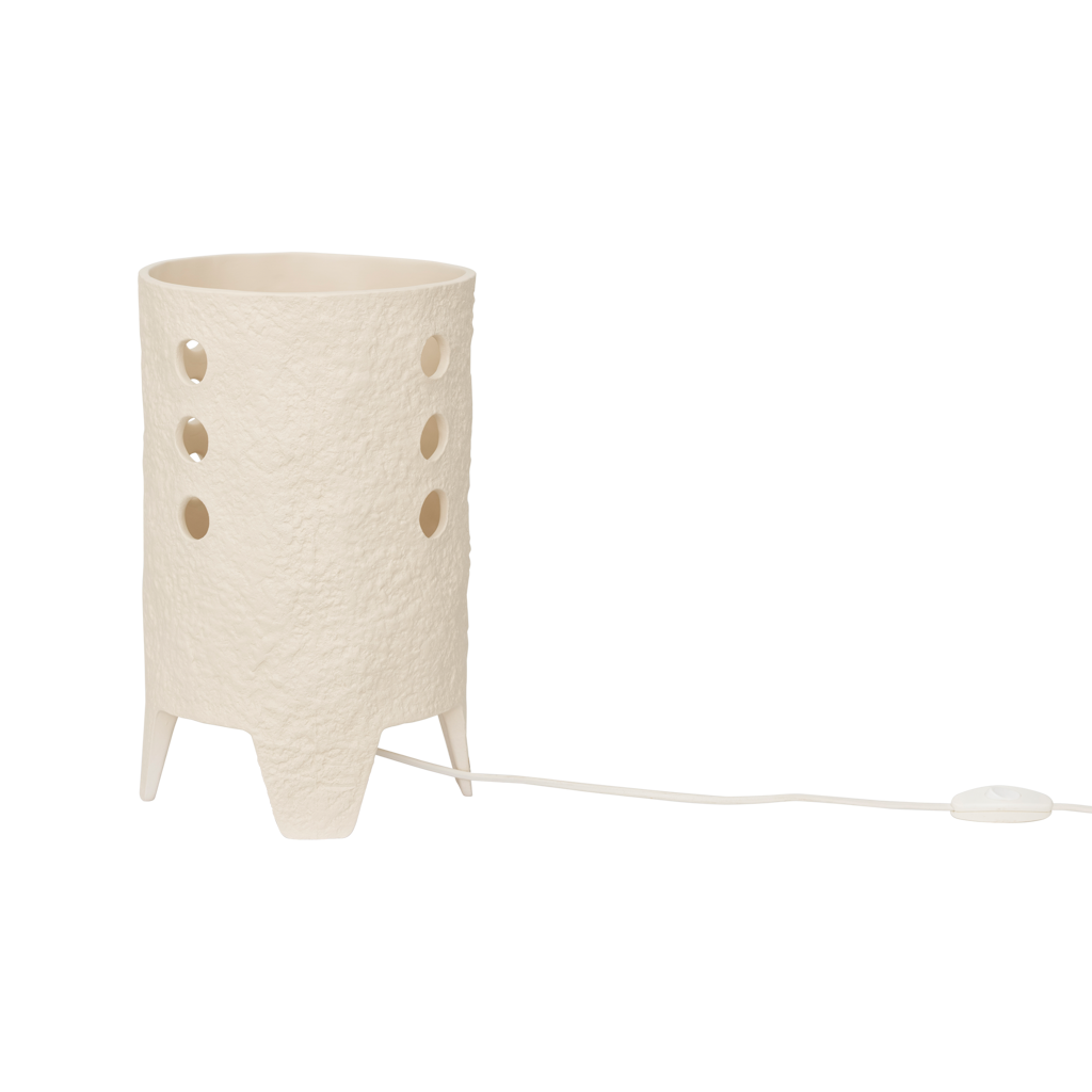 A textured and tactile ceramic table lamp in an handcrafted shape, in the soft colour almond milk. Its design brings expression but also calm, grounded presence.