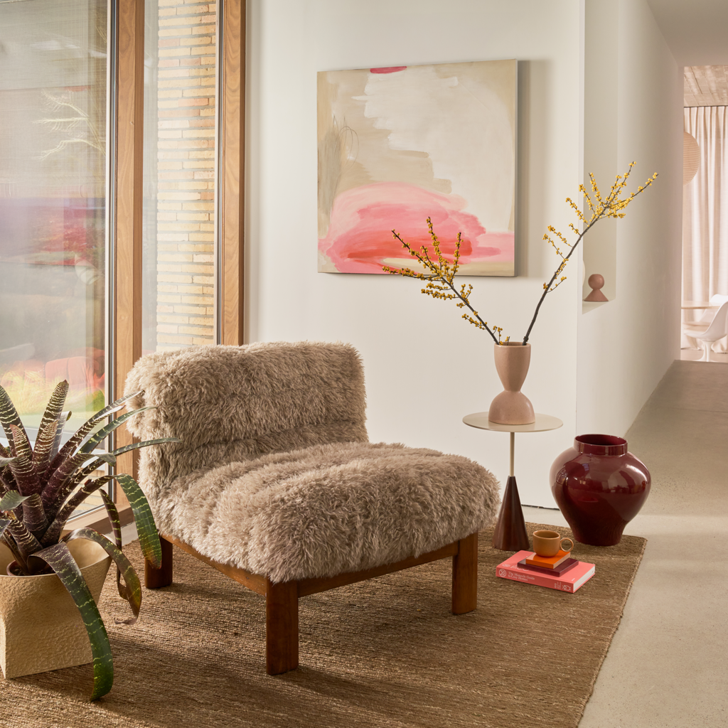 A very large abstract hand painted wall decor in soft pink, sand tones and off-white, adding a playful and uplifting touch to your space.