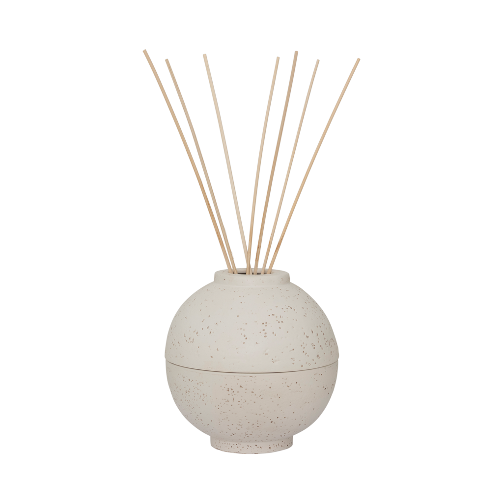 A spherical fragrance holder in off-white with a subtle textured skin, designed to store your whole fragrance bottle with an opening for scented sticks.